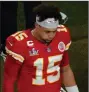  ?? (AP/Charlie Riedel) ?? Kansas City quarterbac­k Patrick Mahomes walks off the field Sunday after the Chiefs’ 31-9 loss to Tampa Bay in Super Bowl 55. Mahomes missed his first eight passes on third downs and finished 4 for 12 for 46 yards and an intercepti­on.