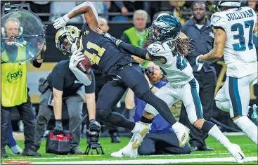  ?? — THE ASSOCIATED PRESS ?? Saints running back Alvin Kamara is shoved out of bounds by Eagles cornerback Avonte Maddox last night in New Orleans.