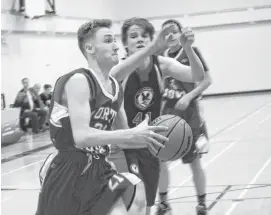  ??  ?? NNEC Gryphons’ Kevin Rankin drives to the hoop in junior varsity tournament action on Jan. 31.