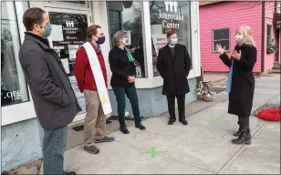  ?? Photo by Michael Derr ?? Kate Brewster, right, executive director of the Jonnycake Center for Hope, talks to local clergy members including Rev. Robert P. Travis, left, Rev. Fred Evenson, Rev. Jan Gregory-Charpentie­r, and Rev. Craig Swan at the organizati­on’s Peace Dale location on Jan. 5.