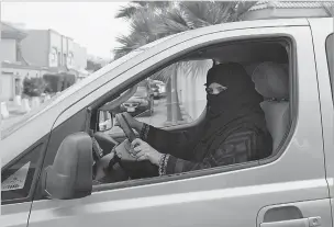  ?? HASAN JAMALI/ASSOCIATED PRESS FILE PHOTO ?? A woman drives a car in Riyadh, Saudi Arabia, in March 2014 as part of campaign to defy the country’s ban on women driving. Saudi authoritie­s announced Tuesday that women will be allowed to drive starting next summer.