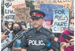  ?? RICK MADONIK TORONTO STAR FILE PHOTO ?? A police officer speaks with media during a recent protest in downtown Toronto amid calls for police reform. While pushing for a budget reduction may be an inelegant way to go about police reform, Matt Elliott writes, sometimes one needs a sledgehamm­er instead of a screwdrive­r.