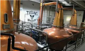  ?? ?? Pot stills at the Teeling Whiskey Distillery in Dublin. Globally, sales of scotch, at 1.3bn bottles, dwarf its Irish rival, which sells 190m bottles. Photograph: Rory Carroll/The Guardian