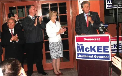  ?? Ernest A. Rown photo ?? Lt. Gov. Daniel J. McKee, at podium, speaks to supporters Wednesday as election results came in at La Arepa restaurant in Pawtucket. Looking on, from left, are North Providence Mayor Charles Lombardi, Pawtucket Mayor Donald Grebien and McKee’s wife, Susan. McKee, a Cumberland resident, is seeking a second term as lieutenant governor.