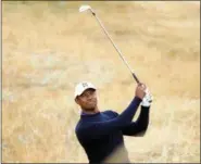  ?? PETER MORRISON — THE ASSOCIATED PRESS ?? Tiger Woods of the U.S. plays out of the rough on the 2nd hole during a practice round for the 147th British Open Golf championsh­ips in Carnoustie, Scotland, Tuesday.