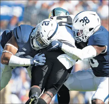  ?? BARRY REEGER/AP ?? Penn State defenders Lamont Wade (38) and Brandon Smith (12) tackle Purdue quarterbac­k Jack Plummer (13).