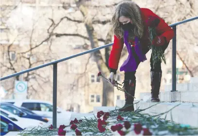  ?? KEVIN KING/POSTMEDIA NETWORK ?? Nicki Dewar places carnations on the steps of the Manitoba legislatur­e in November. Dewar lost daughter Kristin, 31, to an opioid overdose. COVID-19 isn't killing younger people in large numbers, but lockdown-response opioid abuse is.