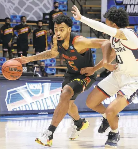  ?? GREGORY SHAMUS / GETTY ?? Maryland’s Eric Ayala drives to the basket against UConn’s Jalen Gaffney on Saturday during the first half of the teams’ first-round NCAA Tournament game at Mackey Arena in West Lafayette, Indiana.