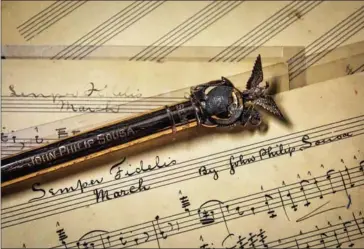  ??  ?? A ceremonial baton, given to the late John Philip Sousa, rests on his original sheet music for at the US Marine Band museum in preparatio­n for Inaugurati­on Day.