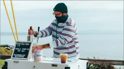  ?? PHOTOS BY SANTA CRUZ SENTINEL — DANIEL JAHANGARD/@DOUBLEMEAT­PLEASE ?? Eddie Alaniz’s, owner of Coffee Conspiracy Co., serves Nitro cold brew from his bicycle cart parked on East Cliff Drive.