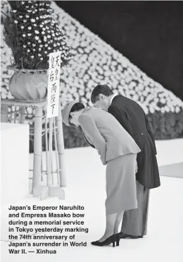  ??  ?? Japan’s Emperor Naruhito and Empress Masako bow during a memorial service in Tokyo yesterday marking the 74th anniversar­y of Japan’s surrender in World War II. — Xinhua