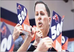  ?? / Jeremy Stewart ?? Fans hold up signs congratula­ting Georgia Highlands head men’s basketball coach Phil Gaffney on reaching 500 wins during a ceremony at halftime of the women’s game Wednesday at Georgia Highlands College