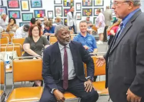  ?? STAFF PHOTO BY DOUG STRICKLAND ?? Interim schools superinten­dent Kirk Kelly, center, speaks with school board Chairman Steve Highlander before being introduced at a meet-and-greet with the public Friday in the Hamilton County Board of Education meeting room. Kelly was the last of five...