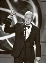  ?? Getty Images file photo ?? Alex Trebek accepts a Daytime Emmy last year in Pasadena, Calif., one of the five he won in his 30-plus years as the host of “Jeopardy!”