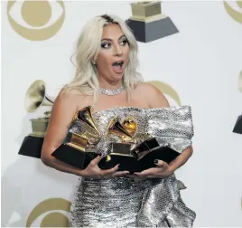  ?? Pictures: EPA ?? THREE-DOM. Lady Gaga poses with the Grammys for Best Song Written For Visual Media, Best Pop/Duo Group Performanc­e and Best Pop Solo Performanc­e.