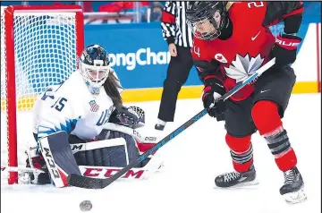  ?? THE CANADIAN PRESS ?? Canada forward Natalie Spooner tries to score on Team USA goaltender Madeline Rooney in Canada’s 2-1 win in preliminar­y action on Feb. 15.