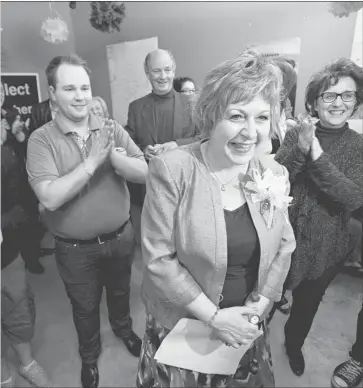  ?? Jordan Verlage, Edmonton Journal ?? Conservati­ve incumbent Heather Klimchuk celebrates with supporters at her campaign office in Edmonton on Monday as the Redford Tories expanded their hold in Edmonton, while losing many southern Alberta seats.