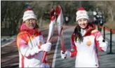  ?? LI HE / XINHUA ?? Former United Nations chief Ban Kimoon joins Chinese athlete Zhang Hong in the torch relay in Beijing on Feb 4.