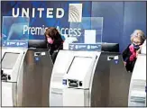  ??  ?? United Airlines employees work at ticket counters in Terminal 1 at O’Hare Internatio­nal Airport in Chicago, on Oct. 14, 2020. (AP)