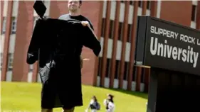  ?? Pittsburgh Post-Gazette ?? Neil Durco shows off his graduation cap and gown at Slippery Rock University in 2013. College Savings Foundation’s 14th annual survey now suggests high school students are again looking toward the traditiona­l college experience after dealing with the COVID-19 pandemic.