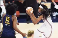  ?? Darron Cummings / Associated Press ?? The Connecticu­t Sun’s Jonquel Jones goes to the basket against the Indiana Fever’s Teaira McCowan on Saturday.