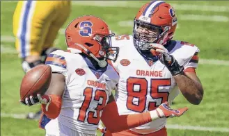  ?? Keith Srakocic / AP ?? Syracuse linebacker Mikel Jones, left, celebrates with Josh Black after recovering a fumble vs. Pitt. The Orange are second nationally in turnovers gained this season.