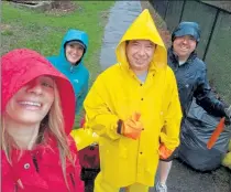  ?? COURTESY SAM SQUAILIA ?? Keep Fitchburg Beautiful Chair Sam Squailia, left, takes a photo after a clean-up last spring. She is joined by Joe Bowen (yellow slicker), Josiah Richards (black slicker) and Melissa Neufell (green slicker) during cleanup of Canton Street.