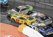 ?? AP ?? NASCAR driver Christophe­r Bell (20) spins out in front of Joey Logano (22), Noah Gragson (42) and Chase Elliott (9) during the Busch Light Clash exhibition race at Los Angeles Memorial Coliseum on Sunday.