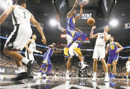  ?? Ronald Cortes / Getty Images ?? The Warriors’ Kevin Durant slams home two of his 24 points as the Spurs’ Pau Gasol ( 16) seems a bit taken aback.