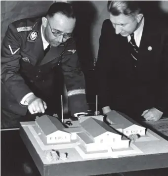  ??  ?? Heinrich Himmler (left) looking at a model with Edgar Haller, who oversaw the design of soldiers’ housing during the Nazi occupation of Norway, circa 1941