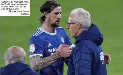  ??  ?? Cardiff City manager Mick McCarthy congratula­tes scorer Aden Flint at the end of the match Picture: Huw Evans
Agency