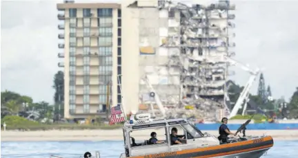  ?? (Photo: AP) ?? A Coast Guard boat patrols in front of the partially collapsed Champlain Towers South condo building, ahead of a planned visit to the site by President Joe Biden, yesterday, in Surfside, Florida.