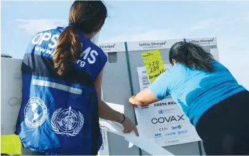  ?? (Mayela Lopez/Reuters) ?? WORKERS MARK a container holding doses of AstraZenec­a’s coronaviru­s vaccine that arrived under the COVAX program in Alajuela, on the outskirts of San Jose, Costa Rica, earlier this month.