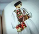  ??  ?? Family pictures of the beginning of the 20th century showing people wearing traditiona­l outfits from the Bihor northweste­rn region of Romania are displayed at the local museum of Beius.