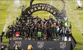  ?? JAY LAPRETE / AP ?? Columbus Crew players raise the cup after defeating the Seattle Sounders in the MLS Cup championsh­ip game Saturday in Columbus. The Crew won 3-0 — the first team to win a major-league title on Ohio soil since the Browns did it in 1964.