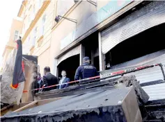  ??  ?? File photo shows the police outside a mosque after it was destroyed by a fire in Berlin. — Reuters photo