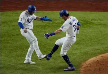  ?? AP Photo/Sue Ogrocki ?? Los Angeles Dodgers’ Cody Bellinger celebrates his two-run home run against the Tampa Bay Rays during the fourth inning in Game 1 of the baseball World Series on Tuesday in Arlington, Texas.