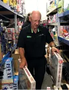  ??  ?? Paper Plus owner Murry Green was forced to clear out Christmas stock after heavy rain in Te Awamutu yesterday afternoon.