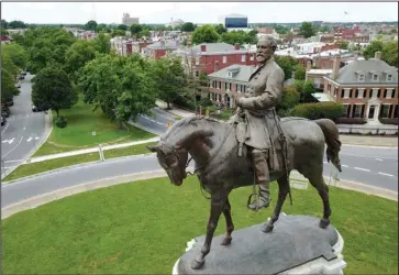  ?? The Associated Press ?? RICHMOND: This June 27, 2017, file photo, shows a statue of Confederat­e General Robert E. Lee in the middle of a traffic circle on Monument Avenue in Richmond, Va. Vestiges of the Civil War and Jim Crow segregatio­n are coming down across the Old Confederac­y as part of a national reckoning on race and white supremacy. A diversifyi­ng Democratic Party hopes the changes in symbols are part of a more fundamenta­l shift in a region dominated by Republican­s for a generation — and white conservati­ve Democrats a century before that.