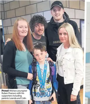  ??  ?? Proud Wishaw youngster Ruben Pearson with his supporters including parents Leanda and Colin