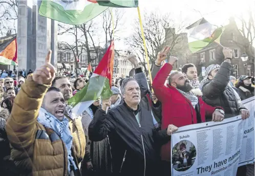  ?? ?? Protesters demonstrat­e in solidarity with the Palestinia­n population outside the Internatio­nal Court of Justice in The Hague