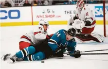  ?? Josie Lepe / Associated Press ?? Hurricanes defenseman Tony DeAngelo (77) collided with Sharks left wing Alexander Barabanov in a fight for the puck.