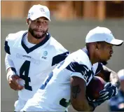  ?? AP PHOTO BY MICHAEL OWEN BAKER ?? Dallas Cowboys quarterbac­k Dak Prescott (4) hands the football to running back Tony Pollard during practice at the NFL football team’s training camp in Oxnard, Calif., Saturday, July 27, 2019.