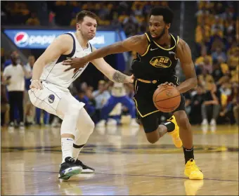  ?? NHAT V. MEYER — BAY AREA NEWS GROUP ?? The Warriors’ Andrew Wiggins (22) dribbles against the Mavericks’ Luka Doncic (77) in the first quarter of Game 1 of the Western Conference finals at Chase Center in San Francisco on Wednesday.