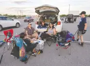  ??  ?? Members of the Bouchard family settle in as they wait for
the show to start Friday at the St-eustache Drive-in.