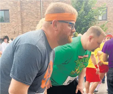  ?? JAY ZAWASKI ?? Jay Zawaski, left, of Homewood, and “I’m Fat Podcast” partner Rick Camp run the Homewood 0.3K in 2019, a race branded by the Homewood Arts Council as “the running event for the rest of us.”