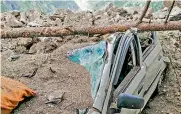  ?? — PTI ?? A car under the debris after a landslide on the Reckong Peo-Shimla Highway in Kinnaur district in Himachal Pradesh on Wednesday.