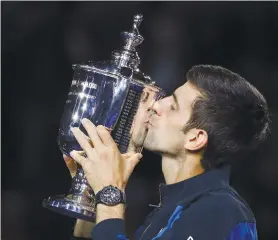  ?? AP FOTO ?? HOW SWEET IT IS. A year after missing the US Open due to an injury, Novak Djokovic lifts his 14th major trophy.