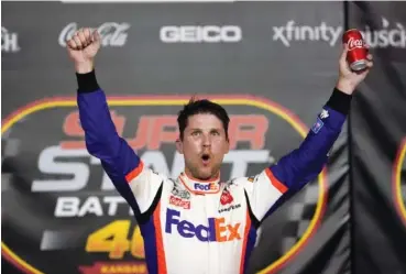  ?? AP PHOTO/CHARLIE RIEDEL ?? Denny Hamlin celebrates after Thursday’s NASCAR Cup Series race at Kansas Speedway, his fifth victory of the season.