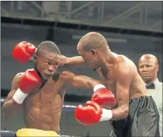  ?? PHOTO: ANTONIA MUCHAVE ?? HARD AT IT: Themba Lesiba (left) battling against Johannes Nthontho in their junior featherwei­ght fight at Wembley Indoor Arena, Johannesbu­rg. Lesiba now takes on Bongani Mahlangu in June.